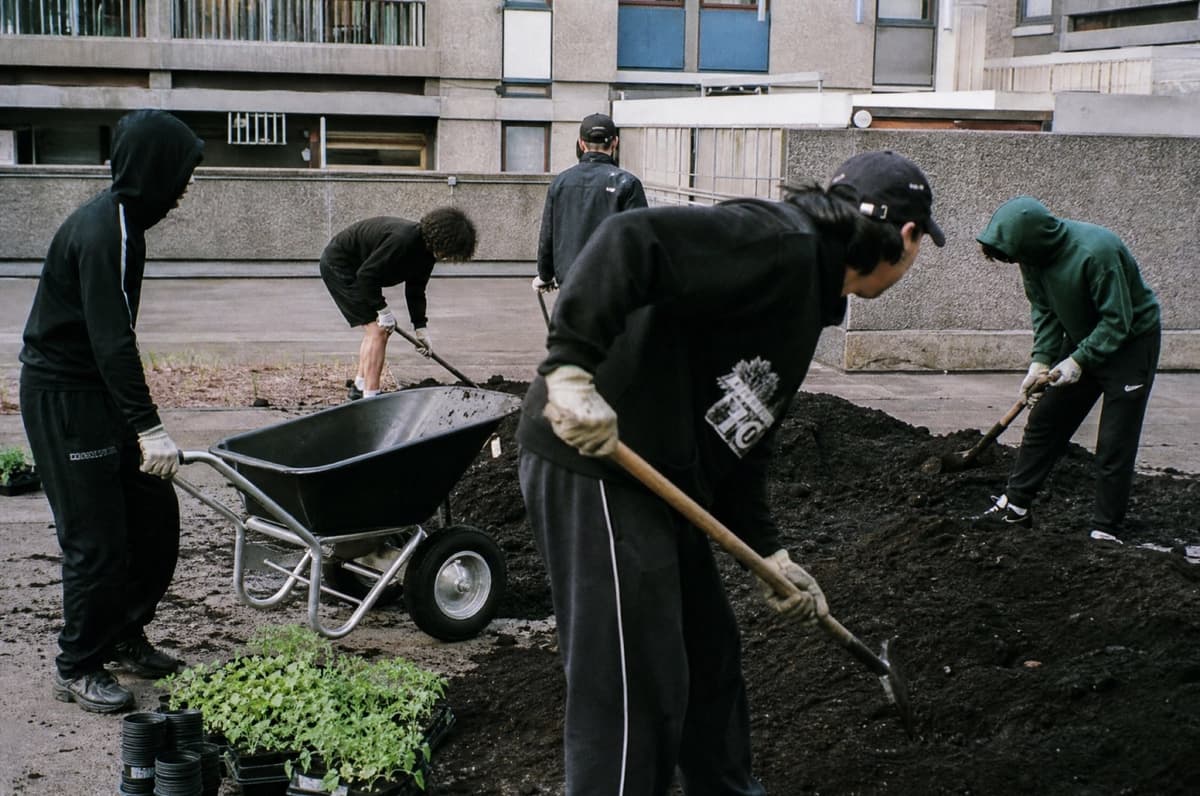 Crew moving soil in a concrete courtyard